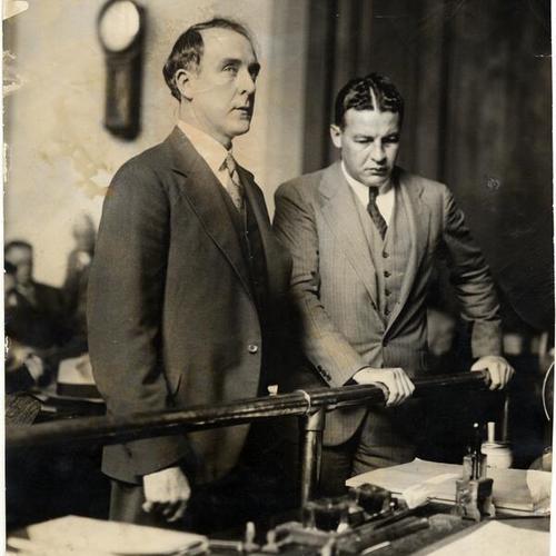 [Frank J. Egan in the Court Room with unidentified man to his right]