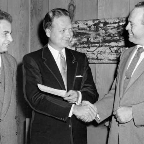 [Representatives of the White House department store receiving a prize from a sales representative of the Leo J. Meyberg Company for a show window display of RCA radios]