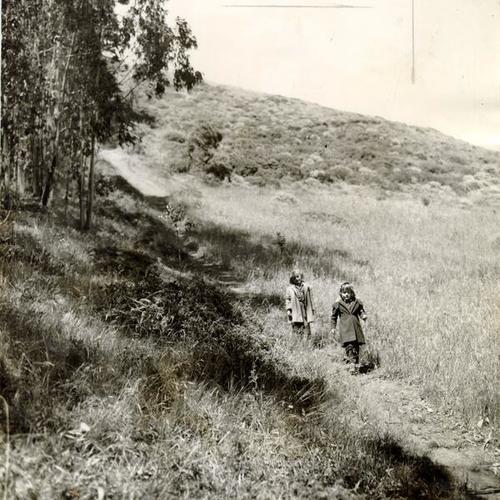 [Two children walking along a path on Mount Davidson]
