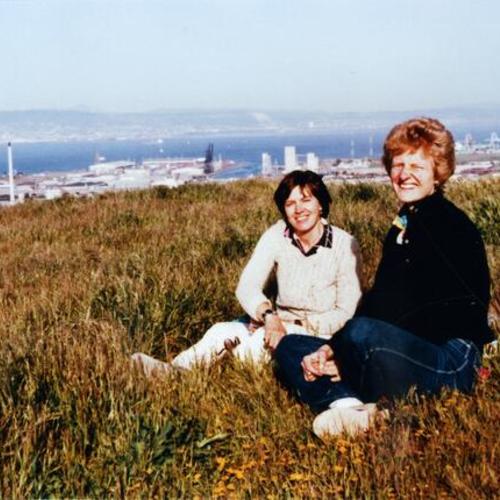 [Zoe with a friend sitting on grass on Potrero Hill in 1985]