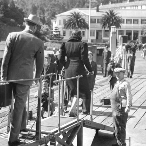 [Harry Bridges and Jacqueline Bridges leaving boat at Angel Island]