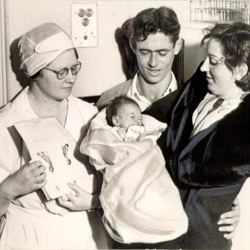 [Unidentified man an woman with new-born baby at Children's Hospital]