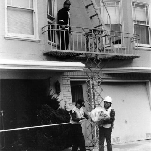 [Firefighters examining a building damaged in the October 17, 1989 Loma Prieta earthquake]