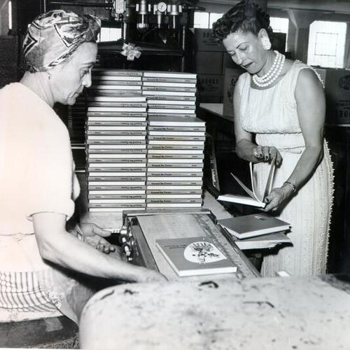 [Carmen Falbo and Roxanna Momjian inspecting books at Cardoza's Bookbindery]
