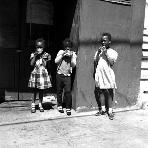 Children eating outside on street