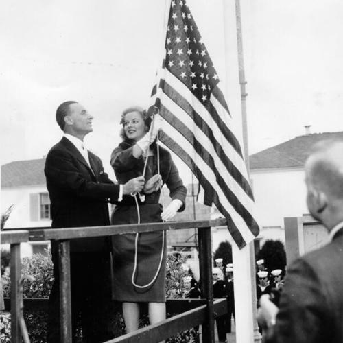 [Dr. Robin Laufer and opera singer Mary Costa raising a flag during a ceremony opening the 43rd season of the San Francisco Conservatory of Music]