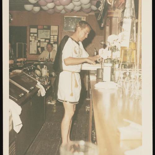 Costumed bartender at cash register