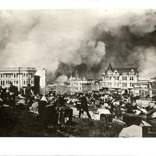 [Refugees gathered in a park near Market and Guerrero streets as city burns in background]