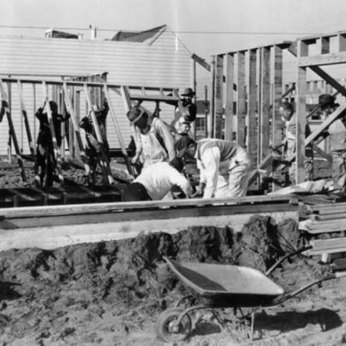 [Volunteer workers and craftsmen helping to complete the construction of the Sunset Lutheran Church]