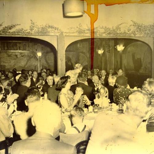 [Unidentified group dining at the New Tivoli restaurant]