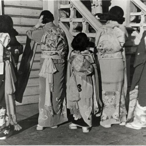 [Rear view of music group wearing kimonos after their performance]