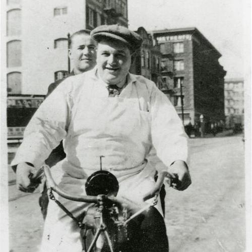 [Portrait of a butcher riding a motorbike with friend]