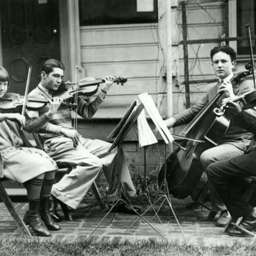 [Community Music Center string quartet in courtyard of music school]
