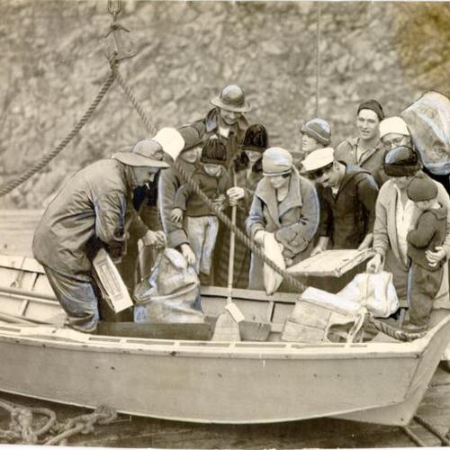 [Group of people receiving supplies on an island in the Farallones]