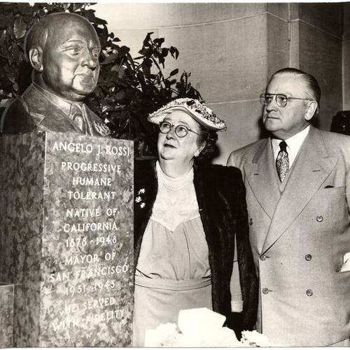 [Mrs. Angelo Rossi and Mayor Elmer E. Robinson viewing a bust of Angelo J. Rossi]