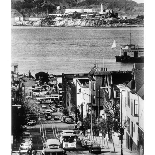[View of cable cars on Hyde Street with Alcatraz Island in background]