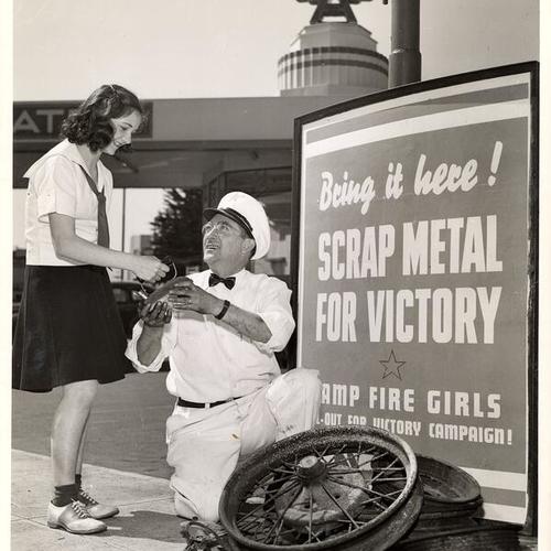 [San Francisco Camp Fire Girl Isabelle Pina donates an electric iron at the service station of Dealer Bill Hunt]