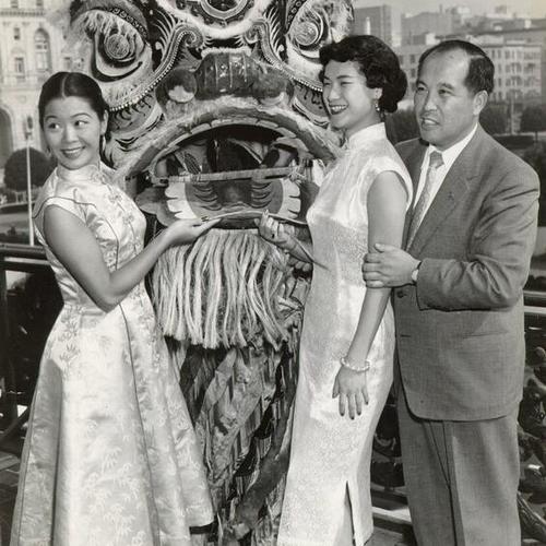 [Esther Wong, Estelle Dong and Earl Louie posing with a lion's mask]