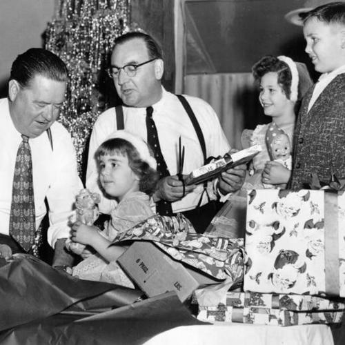 [Attorney General Edmund G. ("Pat") Brown (second from left) helps to prepare for the Moose Christmas party]