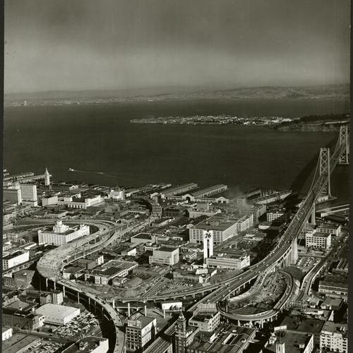 [Construction of Embarcadero Freeway with Treasure Island in the background]