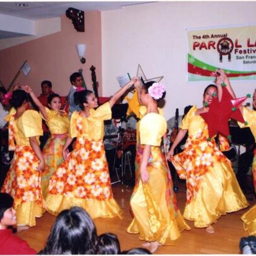 [Local community group dancing for the Parol Lantern Festival at Bayanihan Community Center]