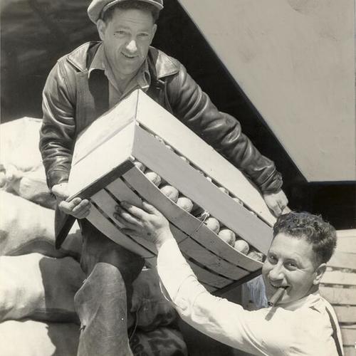 [Two men unloading a produce truck during the general strike of 1934]