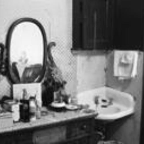 [Lee Washington's room in Daton Hotel, 175 3rd Street, personal items atop dresser next to sink]