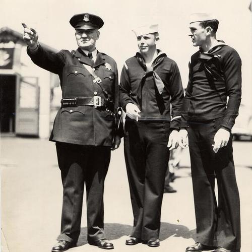 [Officer Con McSweeney talking with sailors Ernest Adams and Joe Hynds]