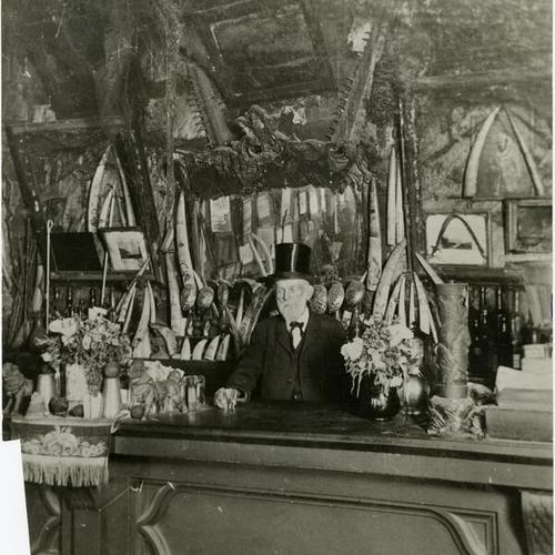 [Man standing behind the bar of Warners Cobweb Palace, Meigg's Wharf]