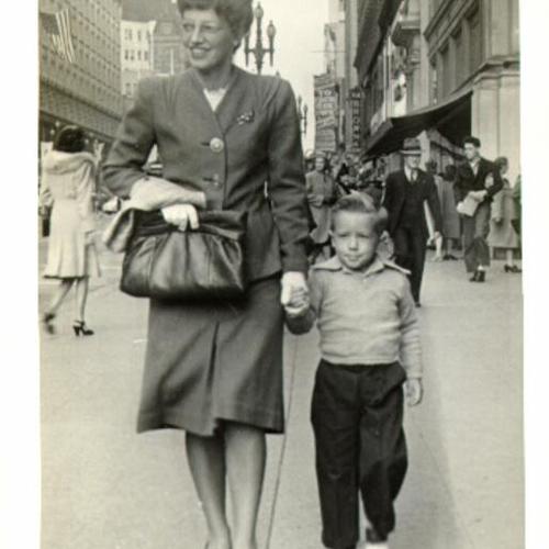 [Ms. J. Toynton and her son John walking along Market Street]
