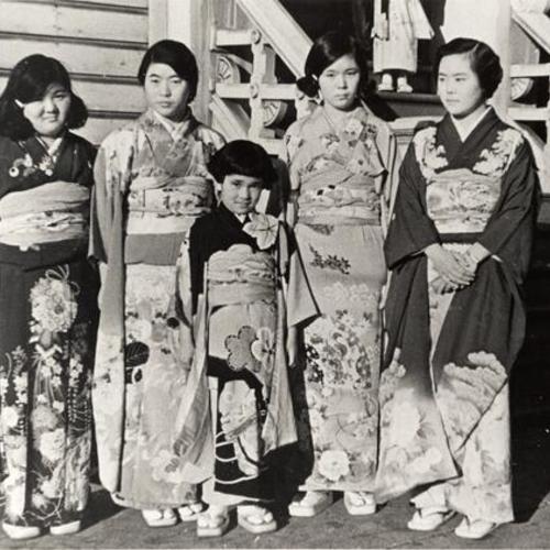 [Front view of music group wearing kimonos after their performance]