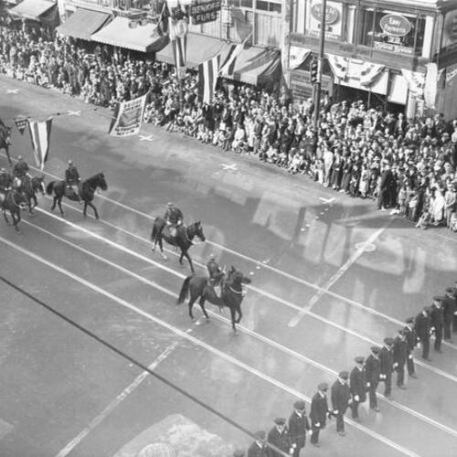 [Officers passing by spectators in the opening day celebration parade for San Francisco-Oakland Bay Bridge]