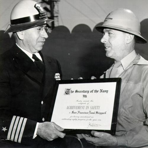 [Captain B. E. Manseau presenting an award to Albert H. Bawden]