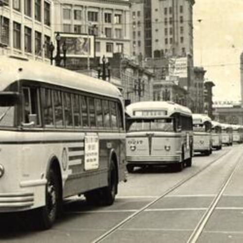 [Buses lining up along Market Street near the Ferry Building]
