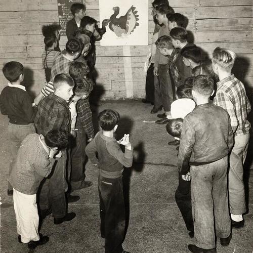 [Members of the Columbia Park Boys Club participating in the 'Turkey Shoot' event]
