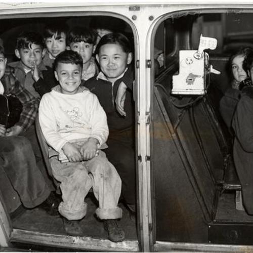 [Students at Irving Scott School receiving taxi ride to school]