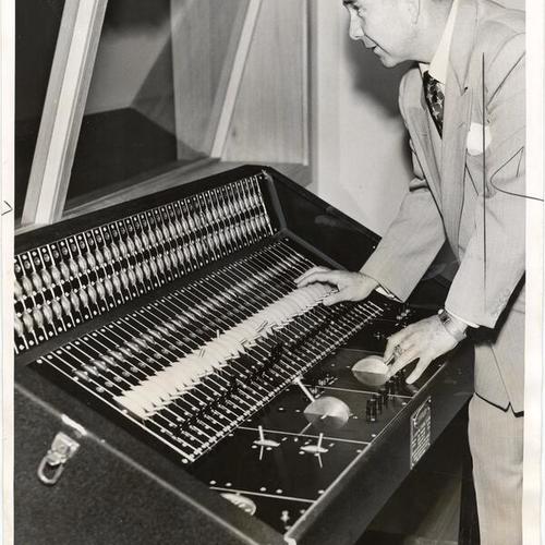 [Dr. J. Fenton McKenna operating a control board in the creative arts building at San Francisco State College]