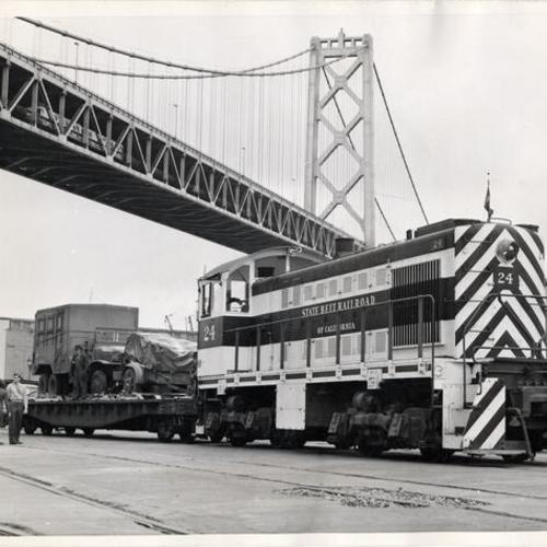 [Freight train stopped underneath the Bay Bridge at the San Francisco waterfront]