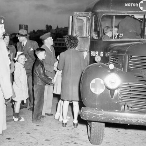 [Families of Alcatraz Prison guards boarding a Red Cross bus during a three day riot at the prison]