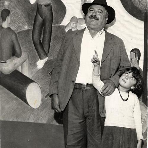 [Louis Pasquale and his daughter Merceda viewing murals inside Coit Tower]