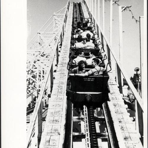 [People riding the roller coaster at the Boardwalk in Santa Cruz]