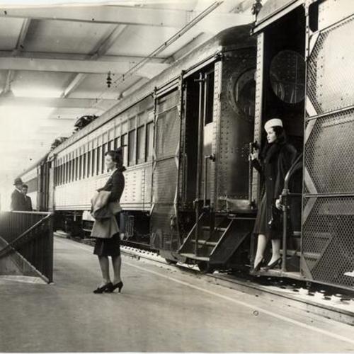 [Gussie Raegener and Carol Hall exiting a train at the Bay Bridge transit terminal]