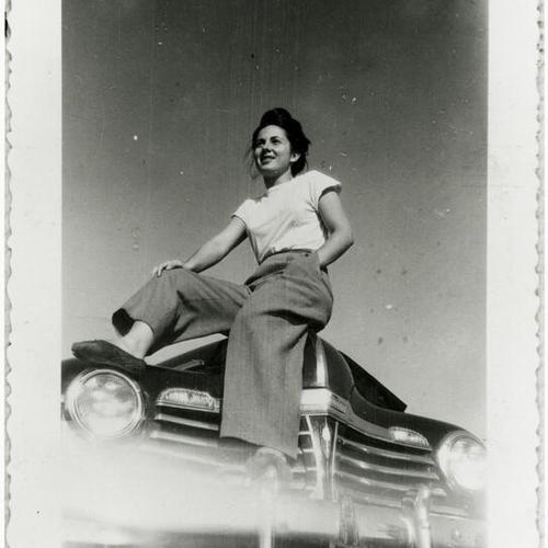 [Ruth sitting on hood of car in 1942]
