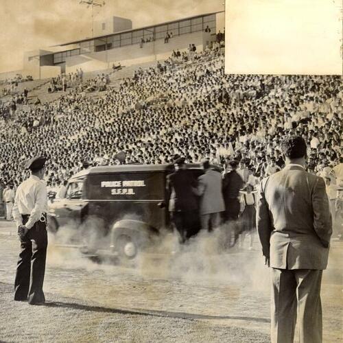 [Police taking rioters off the field at Kezar Stadium]