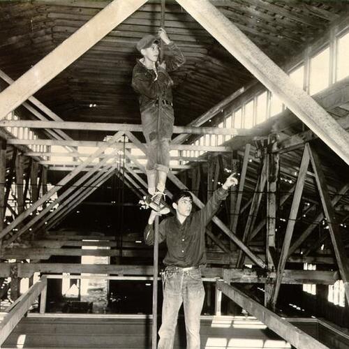 [Two boys playing in the rafters of an old carbarn at 32nd Avenue and Clement Street]