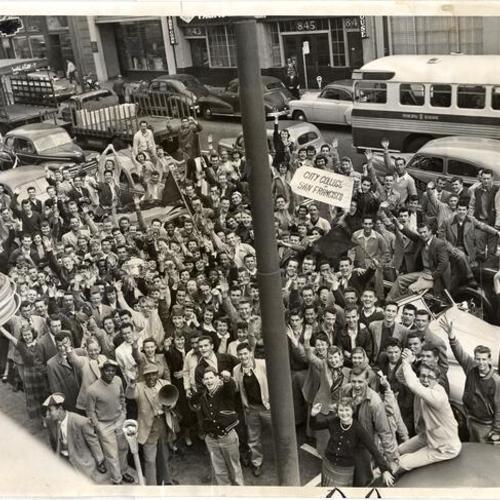 [Group of City College students parading through downtown to publicize their campaign for funds to send the school basketball team to the National Junior College championships in Hutchinson, Kansas]