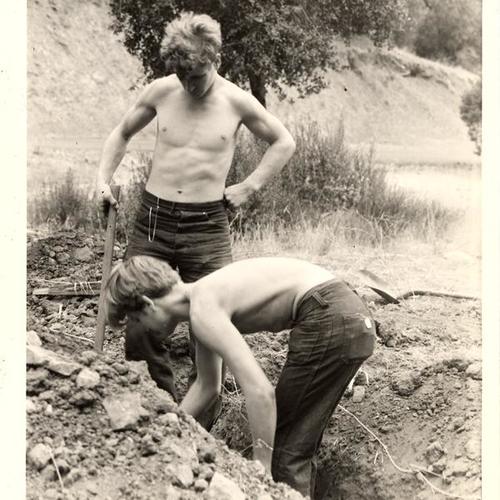 [Two boys working in a ditch at SERA boys shelter Camp Carlton]