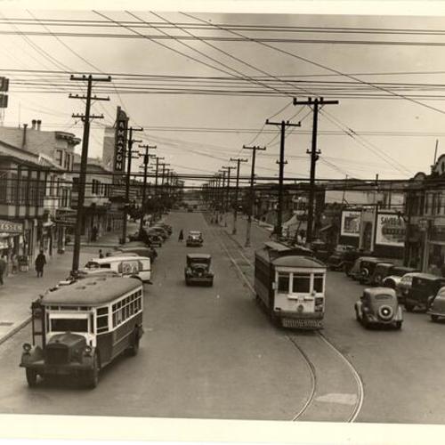 [Geneva avenue at Mission street looking east at Visitacion Valley Line car 735 and Crocker-Amazon line Fageol bus]