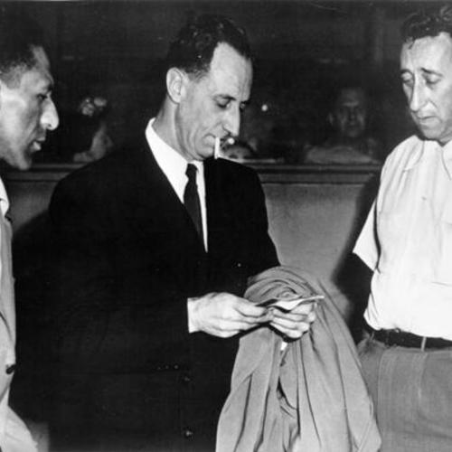 [Harry Bridges (center) CIO Longshore union leader, shown with two other CIO men, Bernard Lucas (left) and Attorney David B. Rothstein]