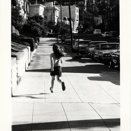 [Girl running along the sidewalk on upper Ashbury Street, near Frederick]